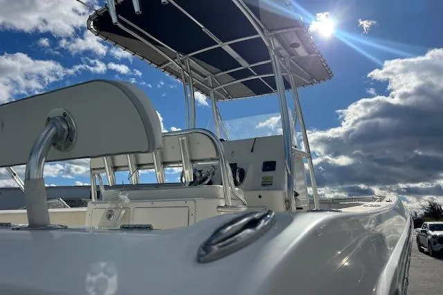 Slide: The Image of 2020 Cobia 237 Center Console boat under a bright, cloudy sky. - 12