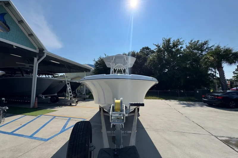 Slide: The Image of 2027 Yellowfin 26 Hybrid boat on trailer under sunny sky. - 6