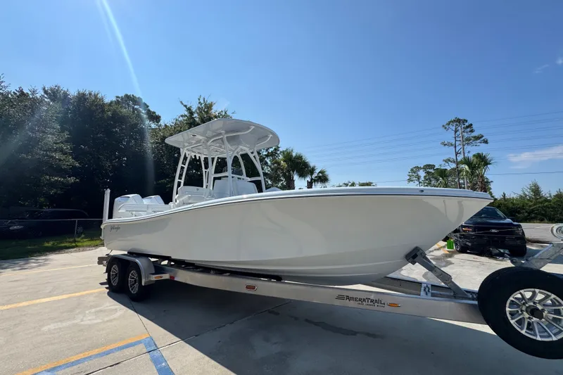 Slide: The Image of 2027 Yellowfin 26 Hybrid boat on trailer under clear blue sky. - 8