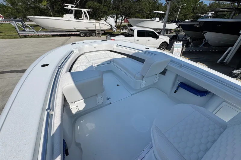 Slide: The Image of 2027 Yellowfin 26 Hybrid boat interior with white seating and spacious deck. - 20
