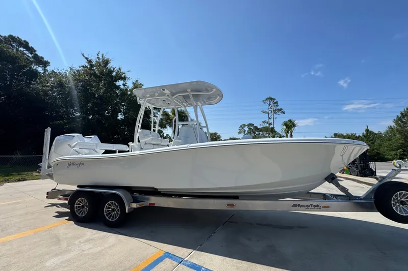 Slide: The Image of 2027 Yellowfin 26 Hybrid boat on trailer under clear blue sky. - 9