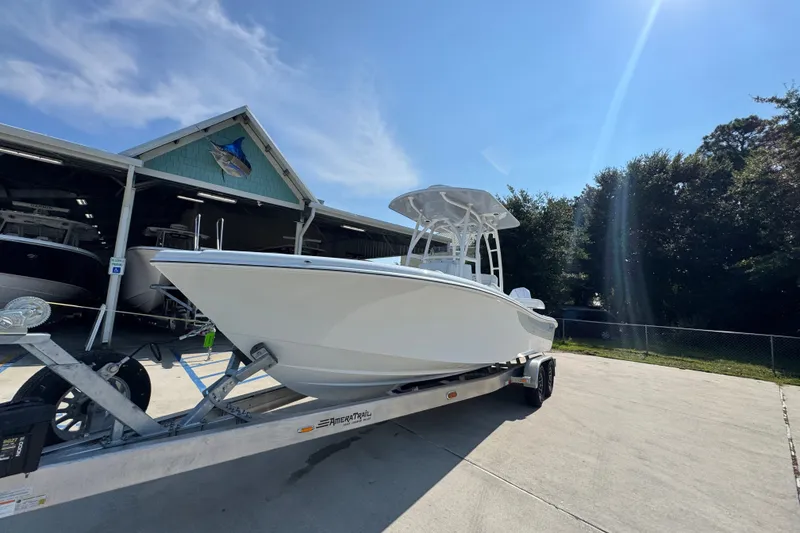 Slide: The Image of 2027 Yellowfin 26 Hybrid boat on trailer under clear blue sky. - 4