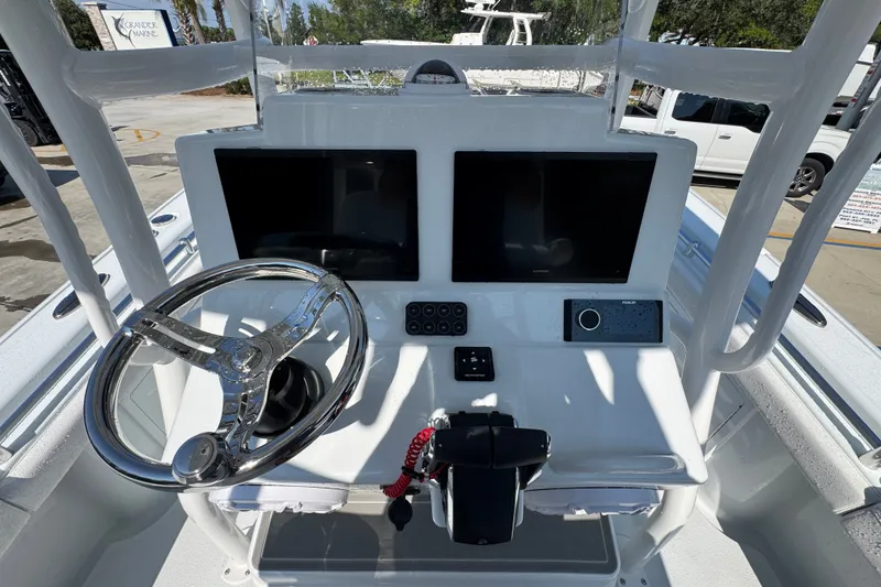 Slide: The Image of Helm of 2027 Yellowfin 26 Hybrid boat with dual screens and steering wheel. - 33
