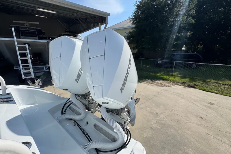 Slide: The Image of 2027 Yellowfin 26 Hybrid boat with dual Mercury outboard engines in a sunny outdoor setting. - 42