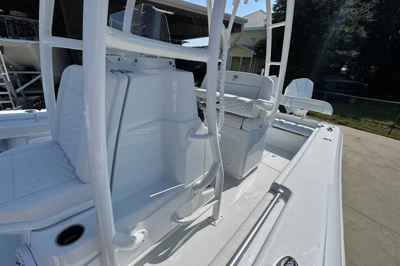 Slide: The Image of 2027 Yellowfin 26 Hybrid boat interior with white seating and console. - 26
