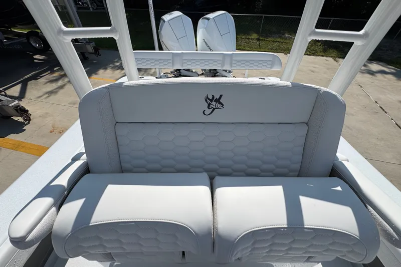 Slide: The Image of 2027 Yellowfin 26 Hybrid boat seat with logo, featuring white cushioned design. - 29