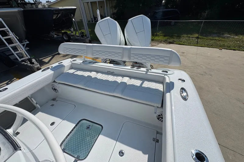 Slide: The Image of 2027 Yellowfin 26 Hybrid boat interior with white seating and storage compartments. - 39