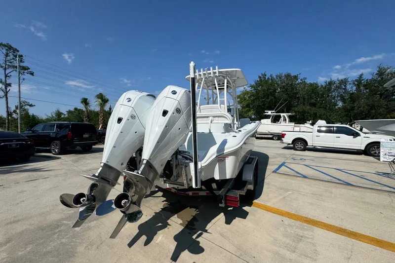Slide: The Image of 2027 Yellowfin 26 Hybrid boat with dual outboard motors on a trailer. - 13