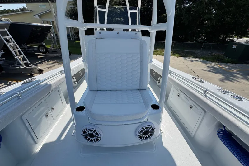 Slide: The Image of 2027 Yellowfin 26 Hybrid boat interior with cushioned seating and speakers. - 24
