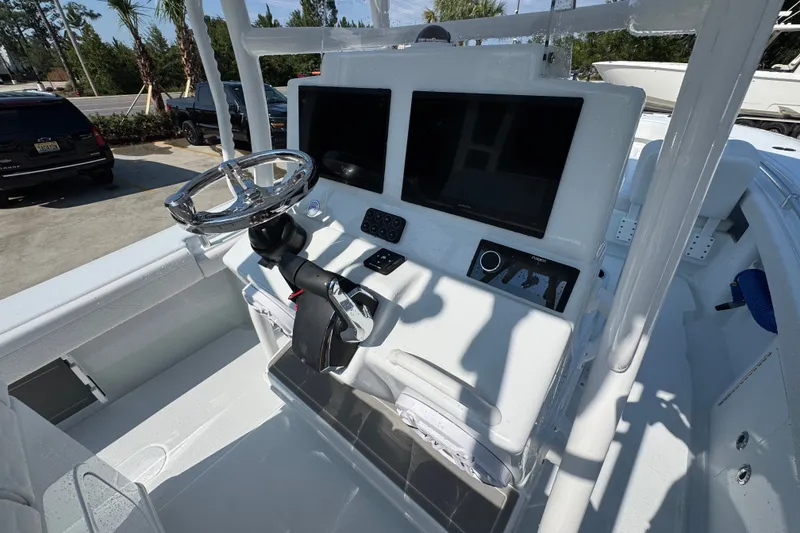 Slide: The Image of 2027 Yellowfin 26 Hybrid boat dashboard with steering wheel and electronic displays. - 35