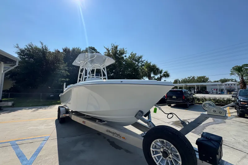 Slide: The Image of 2027 Yellowfin 26 Hybrid boat on trailer under clear blue sky. - 7