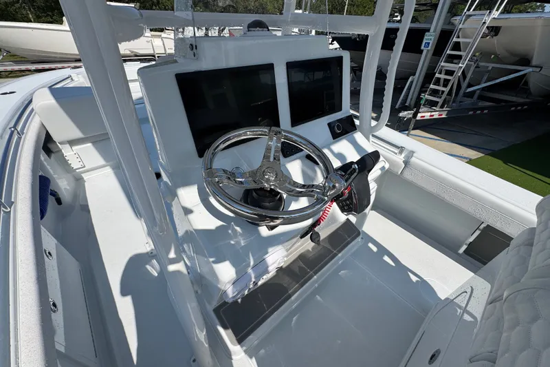 Slide: The Image of 2027 Yellowfin 26 Hybrid boat cockpit with modern steering and dual screens. - 32