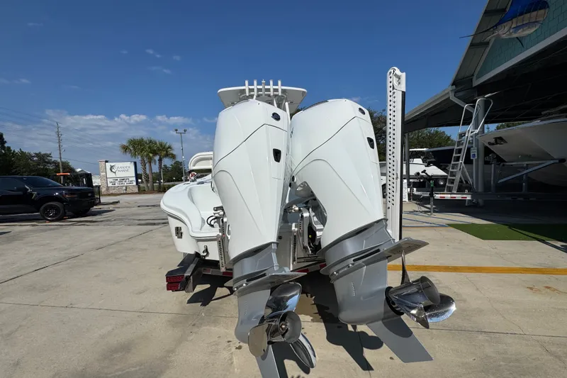 Slide: The Image of 2027 Yellowfin 26 Hybrid boat with dual outboard motors in a marina setting. - 14