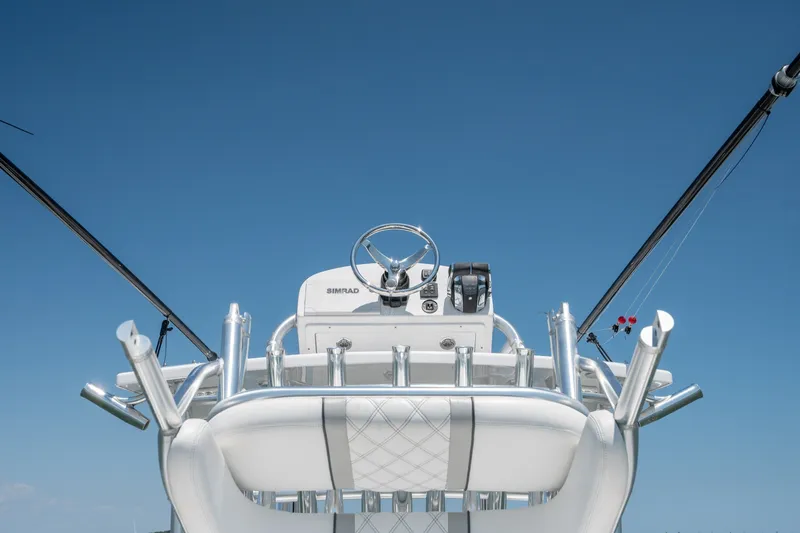 Slide: The Image of 2022 Sea-Lion 34 TE boat helm with steering wheel and controls against clear blue sky. - 33