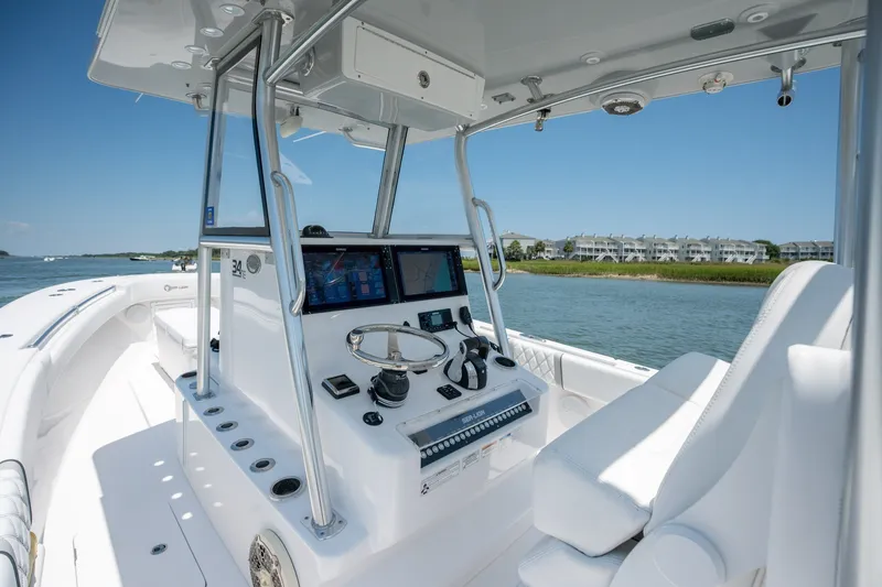 Slide: The Image of 2022 Sea-Lion 34 TE boat cockpit with modern controls, cruising on a sunny day. - 27