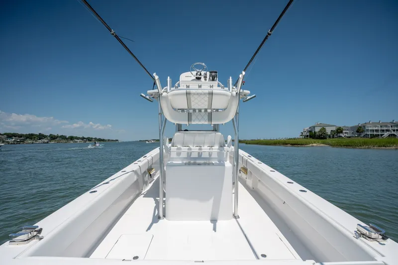 Slide: The Image of 2022 Sea-Lion 34 TE boat on calm water under clear blue sky. - 34