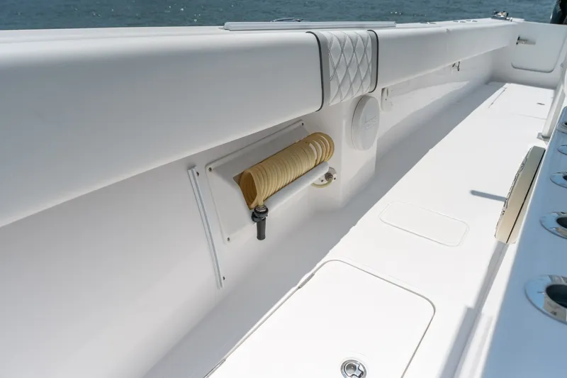Slide: The Image of 2022 Sea-Lion 34 TE boat deck with coiled hose and storage compartments. - 20