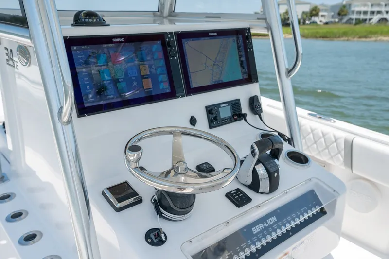 Slide: The Image of Control panel of 2022 Sea-Lion 34 TE boat with dual screens and steering wheel. - 28