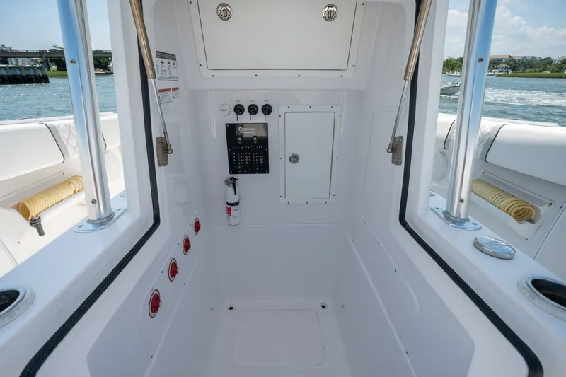 Slide: The Image of Interior view of 2022 Sea-Lion 34 TE boat, featuring control panel and storage compartments. - 19