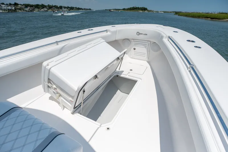 Slide: The Image of 2022 Sea-Lion 34 TE boat interior with open storage compartment on calm water. - 14