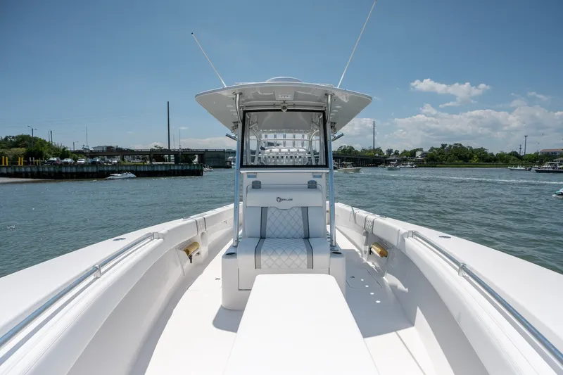 Slide: The Image of 2022 Sea-Lion 34 TE boat on water, featuring sleek white design and spacious deck. - 16