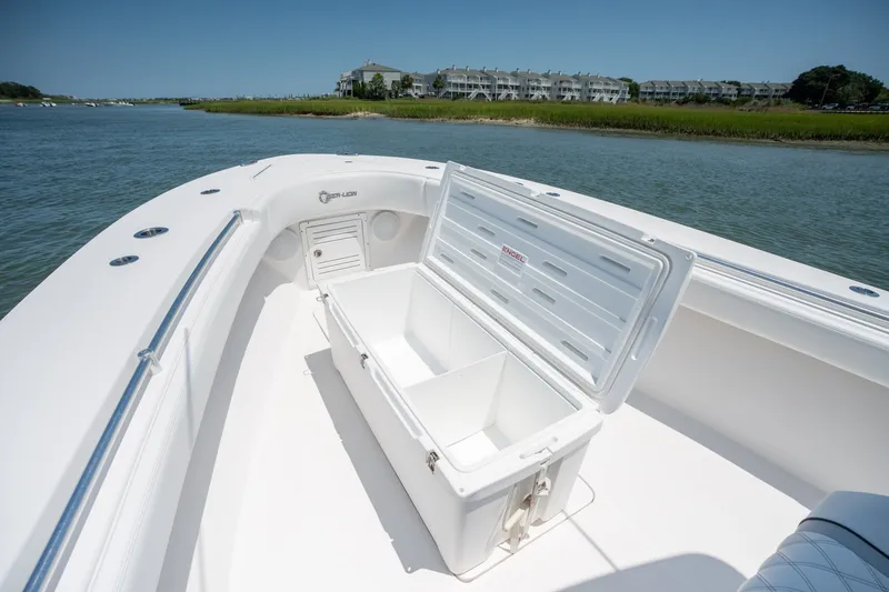 Slide: The Image of 2022 Sea-Lion 34 TE boat with open storage compartment on calm water. - 13