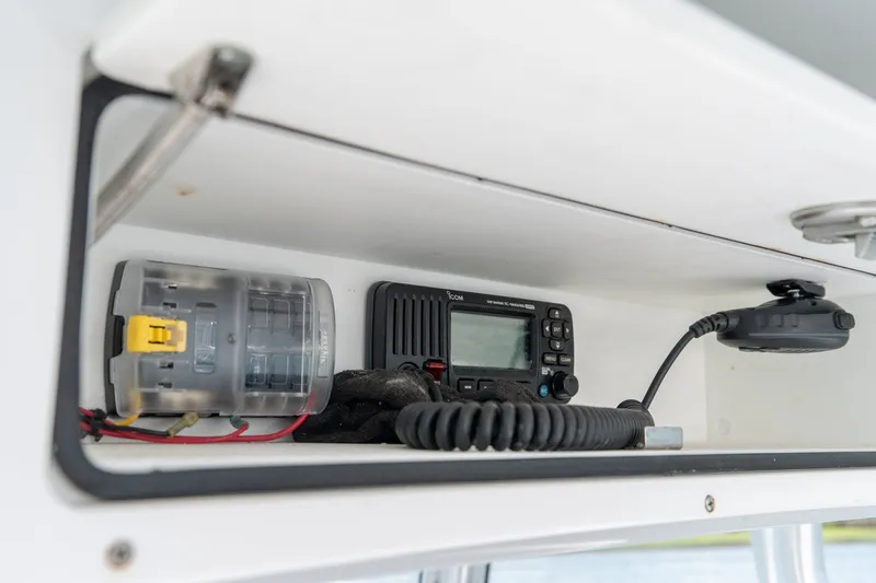 Slide: The Image of 2022 Sea-Lion 34 TE boat electronics compartment with radio and wiring. - 32