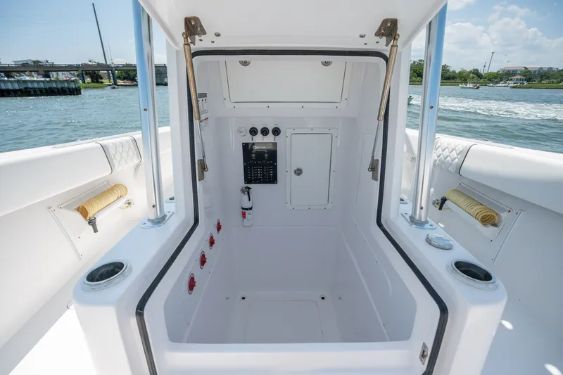 Slide: The Image of 2022 Sea-Lion 34 TE boat interior with control panel and storage, docked by the water. - 18