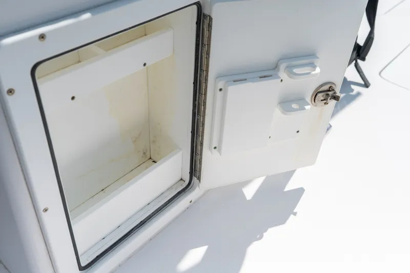 Slide: The Image of Open storage compartment on a 2022 Sea-Lion 34 TE boat, showcasing interior space. - 26