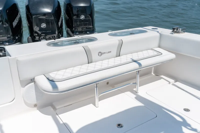 Slide: The Image of 2022 Sea-Lion 34 TE boat with cushioned seating and powerful outboard motors. - 37