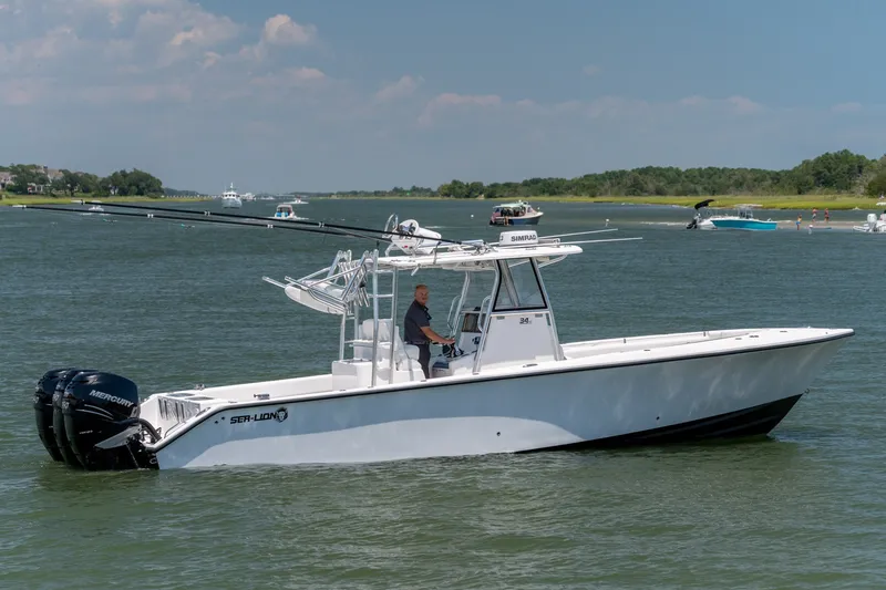 The Image of 2022 Sea-Lion 34 TE boat cruising on a calm lake with scenic background. - 0