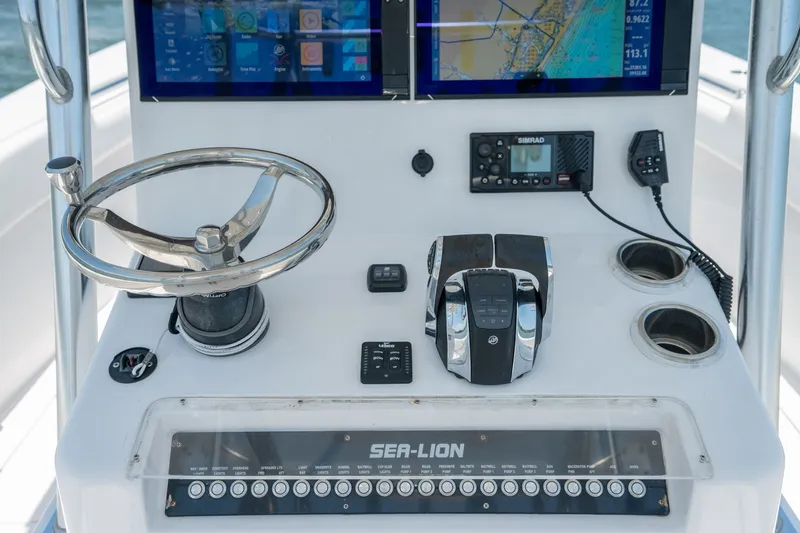 Slide: The Image of 2022 Sea-Lion 34 TE boat dashboard with steering wheel, controls, and navigation screens. - 30