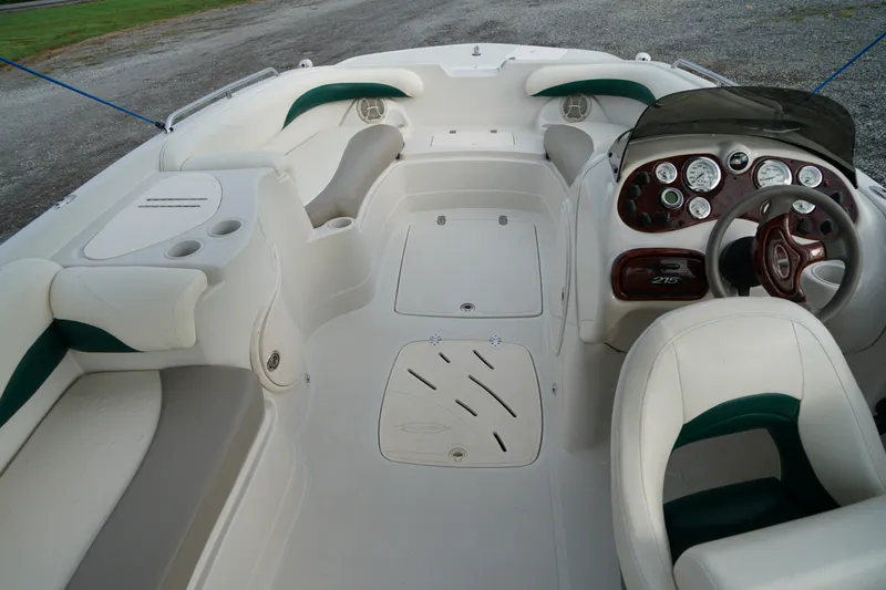 Slide: The Image of 2007 Tahoe 215 I/O boat interior with white seating and dashboard controls. - 14
