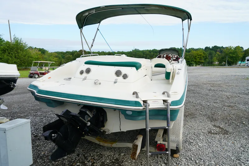 Slide: The Image of 2007 Tahoe 215 I/O boat with canopy, parked on gravel lot. - 11