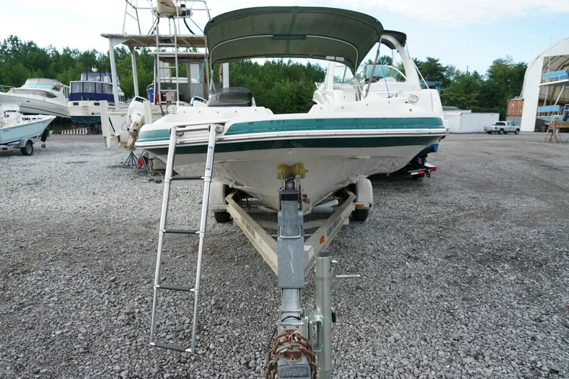 Slide: The Image of 2007 Tahoe 215 I/O boat on trailer in marina, surrounded by other boats. - 9