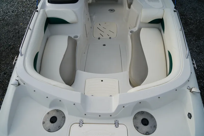 Slide: The Image of 2007 Tahoe 215 I/O boat interior with white seating and green accents. - 22