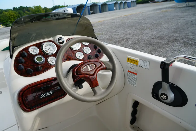 Slide: The Image of Steering console of a 2007 Tahoe 215 I/O boat with gauges and controls. - 16