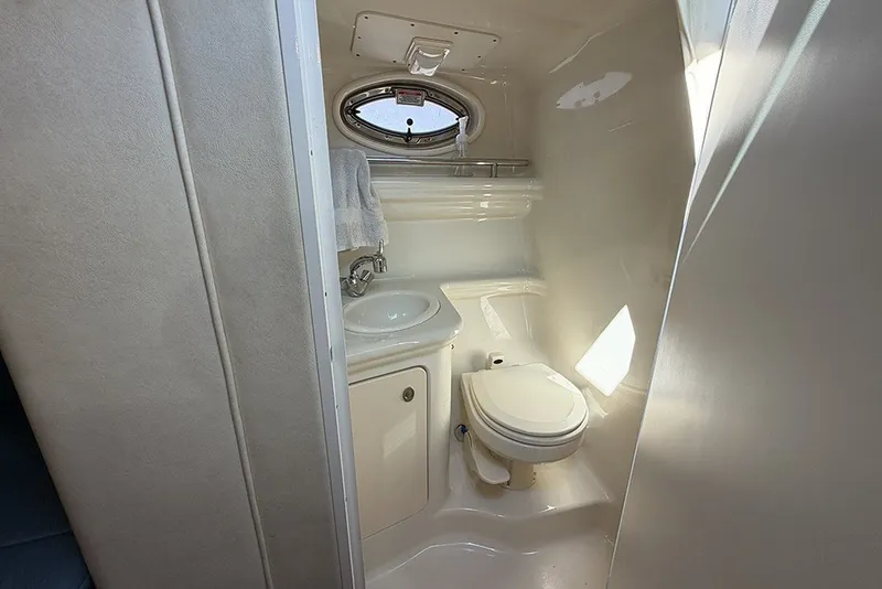 Slide: The Image of Compact bathroom in 2006 Sea Ray 270 Amberjack boat, featuring toilet and sink. - 21