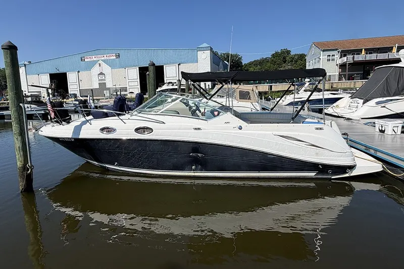 The Image of 2006 Sea Ray 270 Amberjack boat docked at marina with blue sky background. - 0