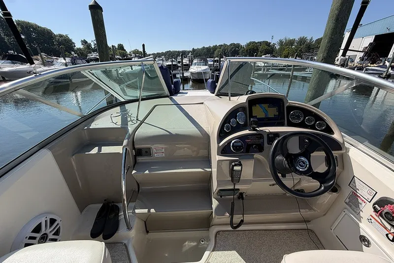 Slide: The Image of 2006 Sea Ray 270 Amberjack boat cockpit with steering wheel and navigation instruments. - 12