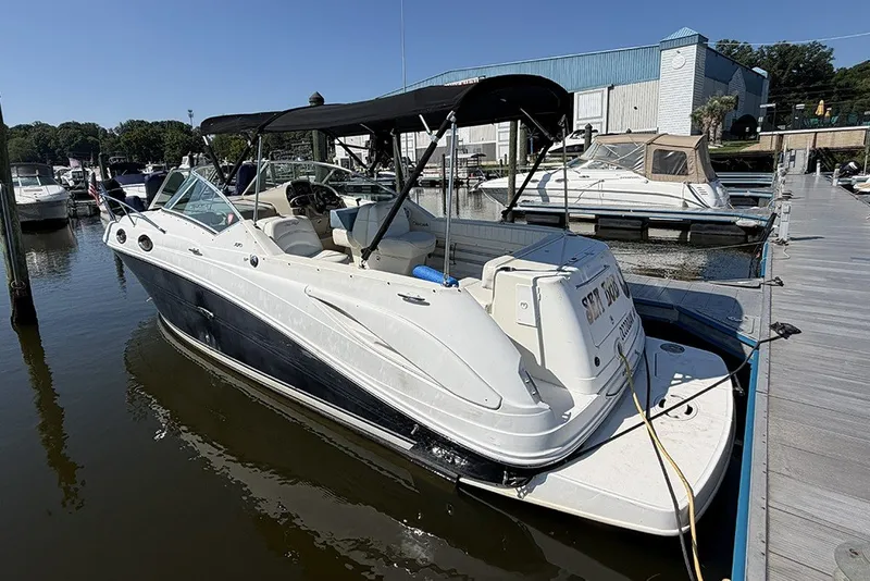 Slide: The Image of 2006 Sea Ray 270 Amberjack docked at marina, featuring sleek design and spacious seating. - 1