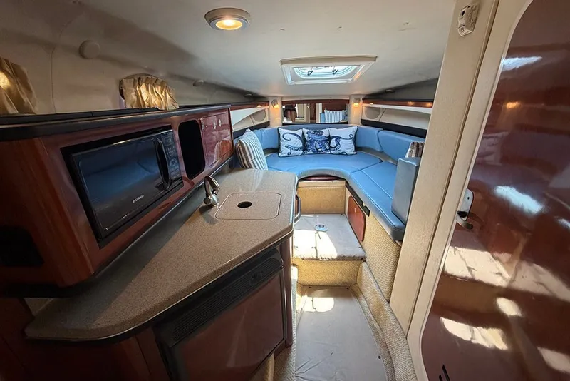 Slide: The Image of Interior of 2006 Sea Ray 270 Amberjack boat with kitchenette and seating area. - 22
