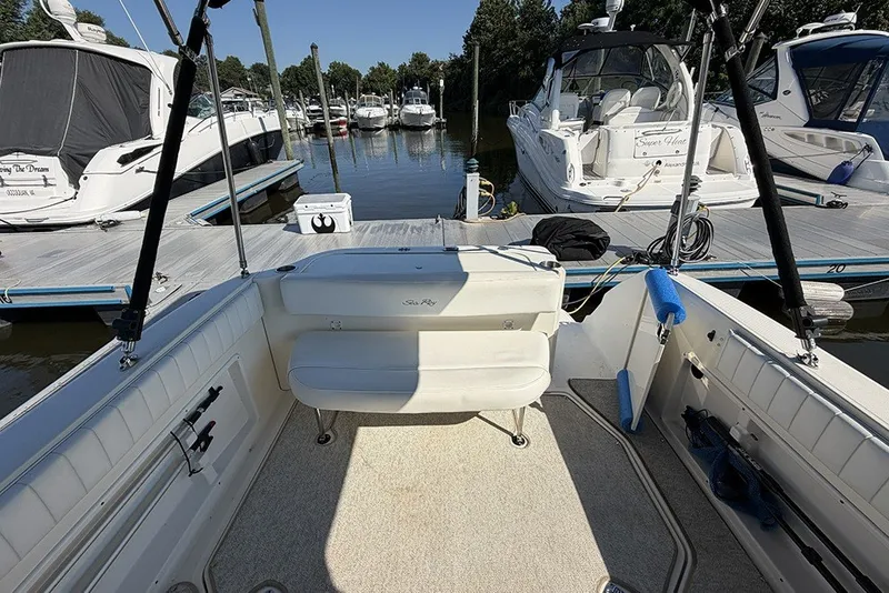 Slide: The Image of 2006 Sea Ray 270 Amberjack boat docked at marina, featuring spacious seating and fishing equipment. - 6