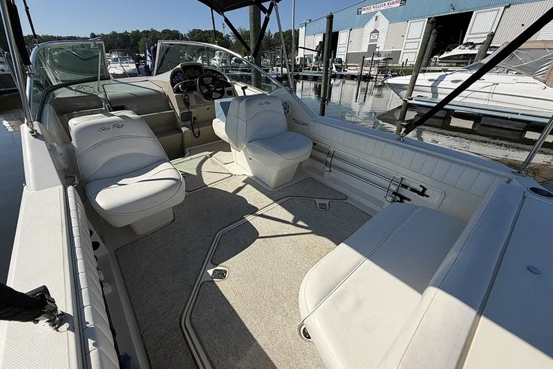 Slide: The Image of 2006 Sea Ray 270 Amberjack boat interior with seating and helm at marina. - 4