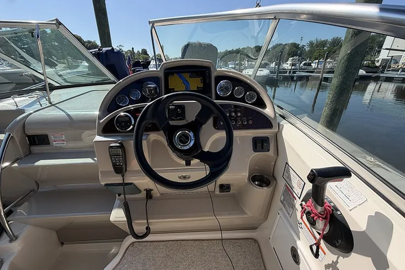 Slide: The Image of 2006 Sea Ray 270 Amberjack helm with steering wheel and navigation instruments. - 10