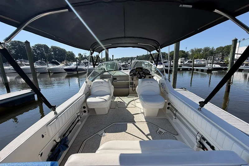 Slide: The Image of 2006 Sea Ray 270 Amberjack boat interior with canopy, docked at marina. - 3