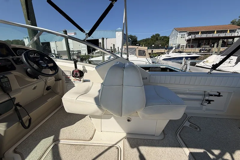 Slide: The Image of Interior view of a 2006 Sea Ray 270 Amberjack boat, featuring helm and seating area. - 9