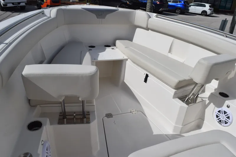 Slide: The Image of Interior of 2027 Sailfish 272 CC boat featuring white seating and cup holders. - 14