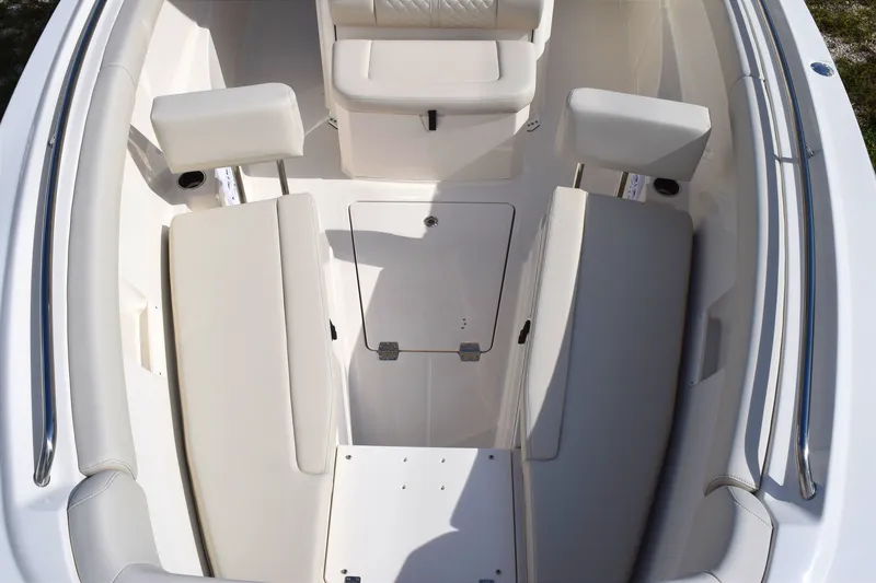 Slide: The Image of The image shows the bow area of a Sailfish 272 CC boat with white cushioned seats. - 15