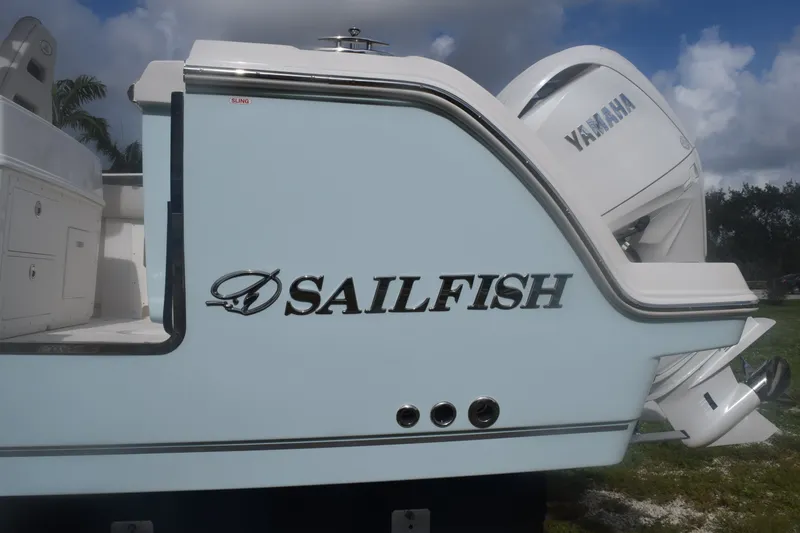 Slide: The Image of 2027 Sailfish 272 CC boat with Yamaha engine, side view under cloudy sky. - 17